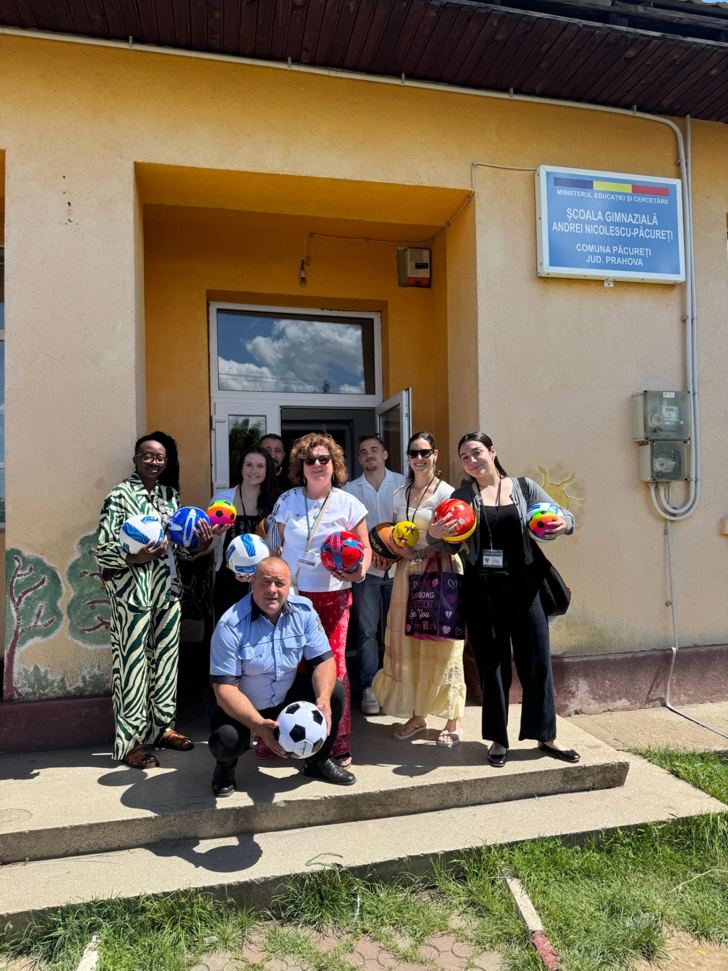 Team delivering donated soccer, basketball, and volleyballs to the local school
